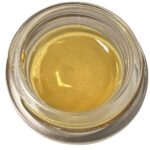 Golden cannabis distillate in a glass jar