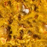 A detailed image of LA Confidential shatter, featuring a smooth and glossy texture in rich amber tones.
