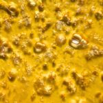 A close-up of Pink Rockstar shatter with a glossy, amber appearance, showcasing its high-quality texture.
