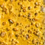 A close-up of Wedding Cake shatter, highlighting its clear, golden texture with a smooth finish.