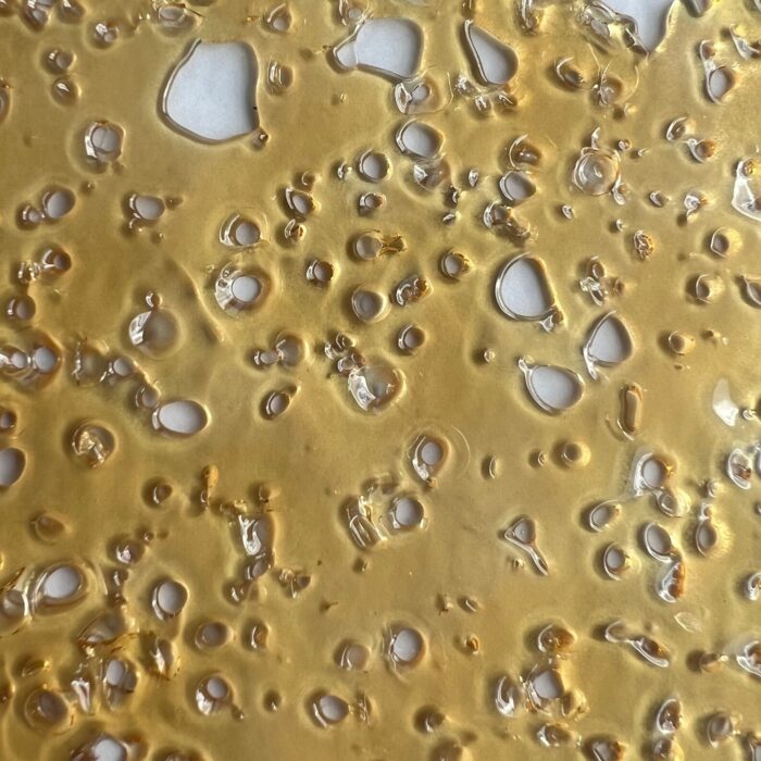 MKU Shatter – Premium cannabis concentrate with a golden, glass-like texture, offering potent effects and a rich citrus-herbal flavor.