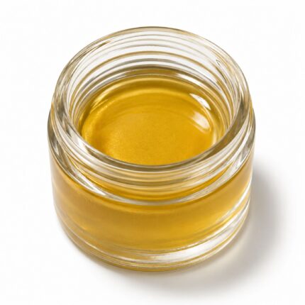 Golden cannabis distillate in a glass jar